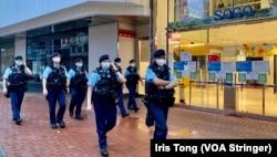 今年7-1刺警案一周年,大批穿上防刺背心、苛枪实弹的军装警员在事发地点铜锣湾崇光百货正门外巡逻。 (美国之音 汤惠芸)