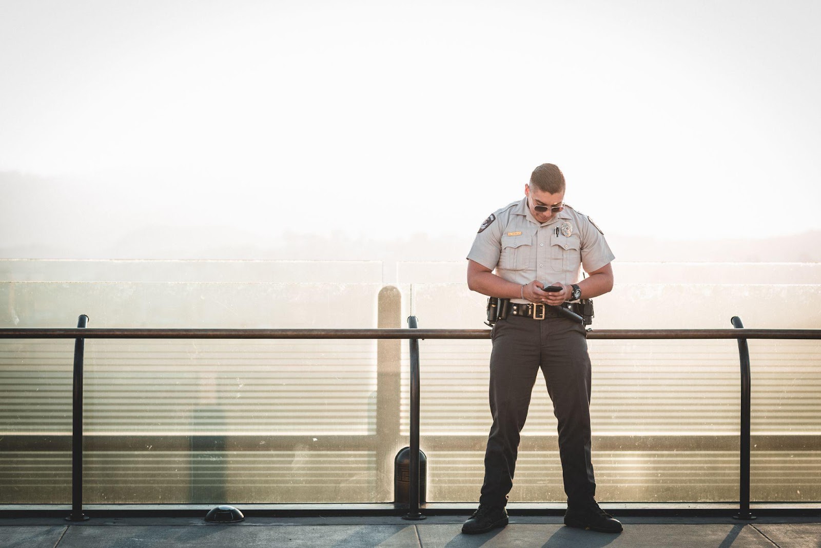 Lone security guard standing in the sun.