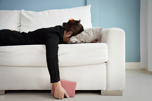 A woman laying on the couch with face down on a pillow and hand falling off the couch. This photo represent fatigue, burnout, and exhaustion from working too much. Therapy for mood disorders in Woodland Hills CA can help with coping with depression using cognitive behavioral therapy. 91364 | 91307 | 91356 | 91301 | 91302 | 91372
91367 