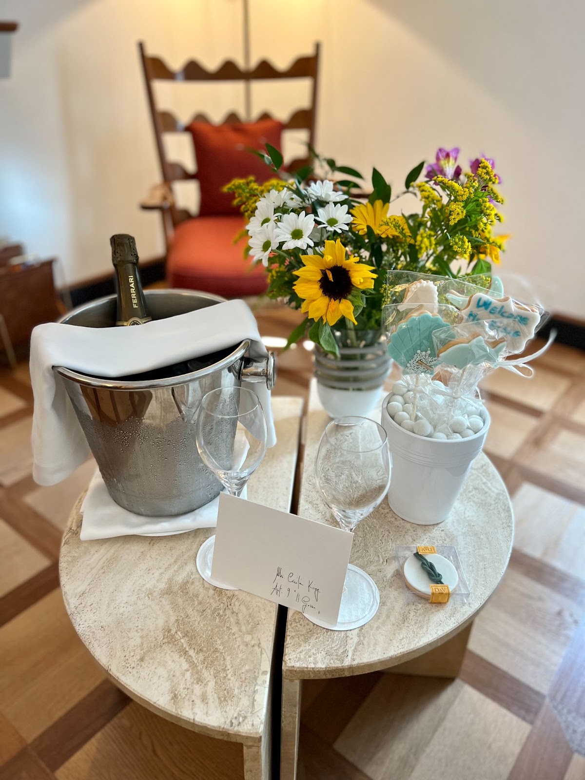 a table with a bucket of wine and flowers