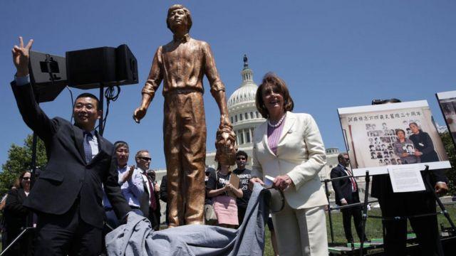 Speaker Pelosi unveils a statue of the 'Tank Man' from Tiananmen Square at a rally with Chinese dissidents in 2019