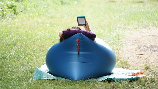 a lady lying on one of the best camping cots and air mattresses