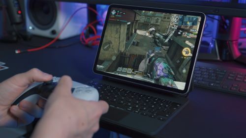 Person learning to earn gift cards by playing games on their laptop gaming device. 