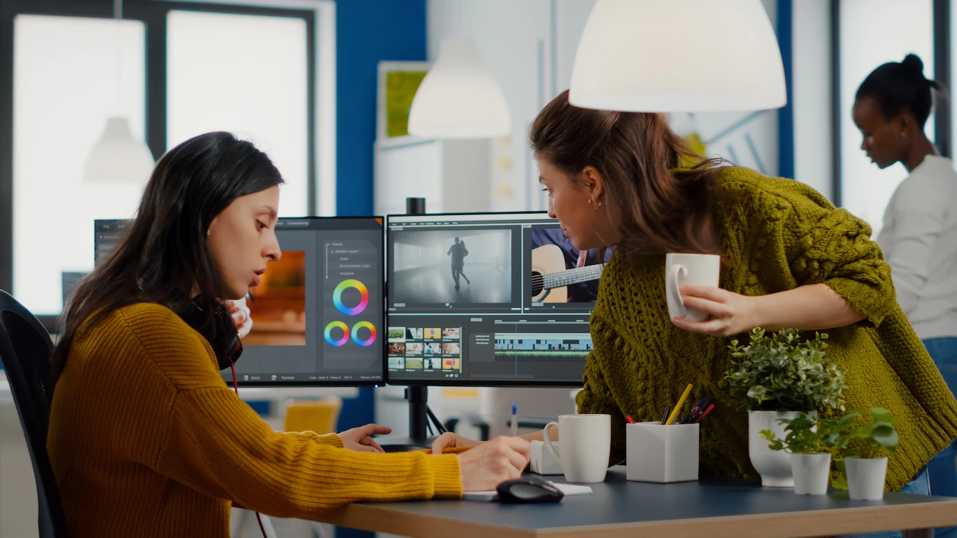 Two women editing video.