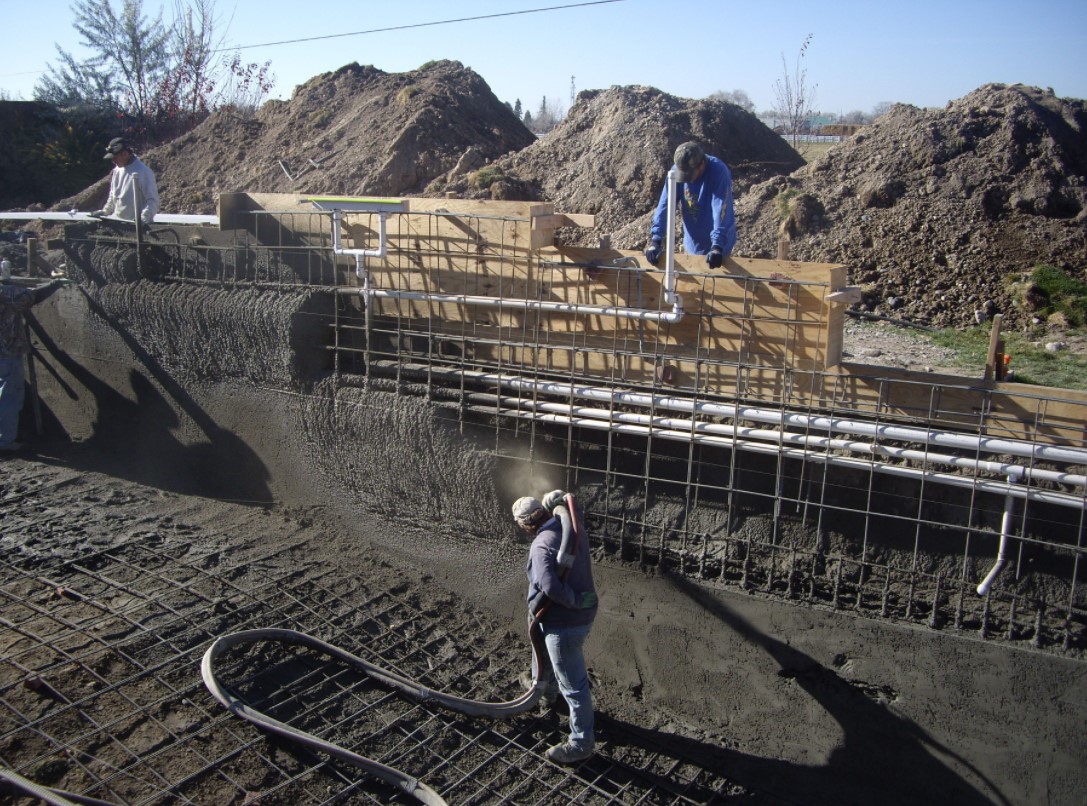 High quality and durable shotcrete is poured into place by construction professionals.