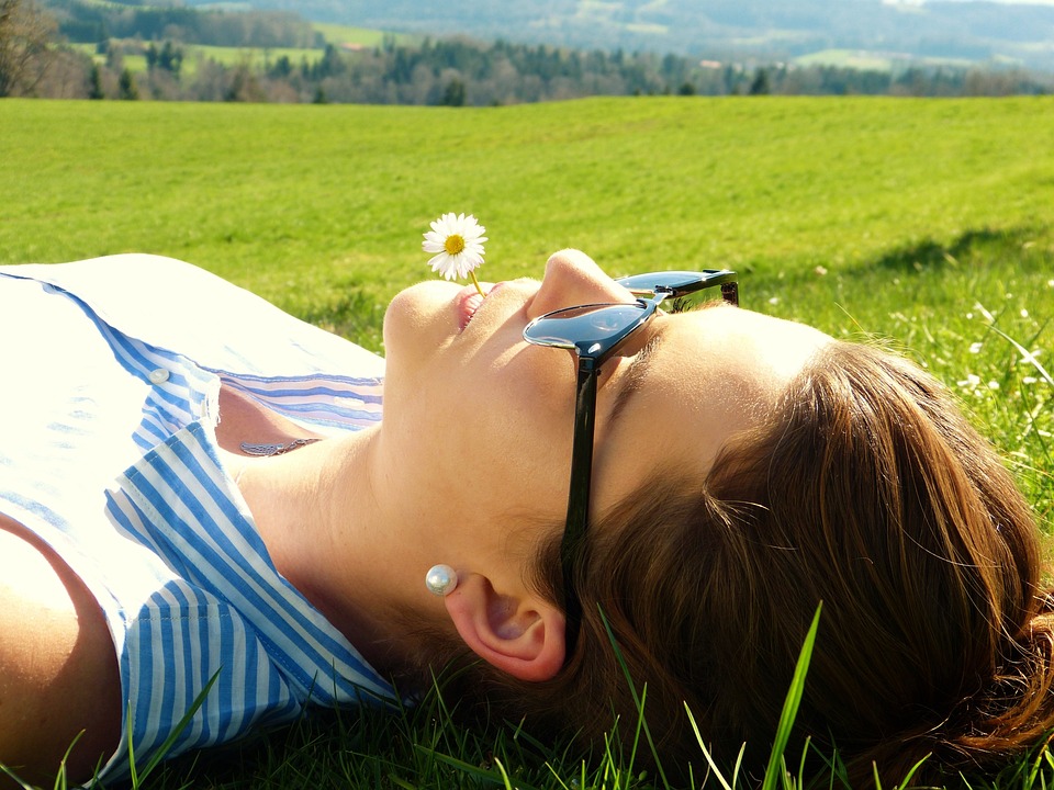 a lady lying in the field- things to do while camping with family