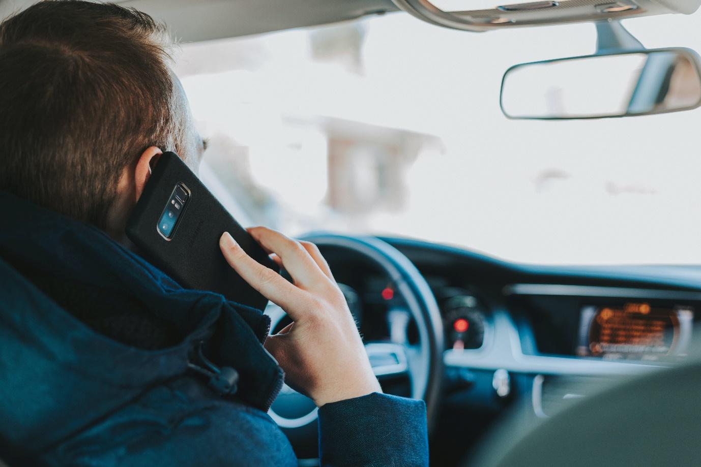 A picture containing person, cellphone, phone, car

Description automatically generated