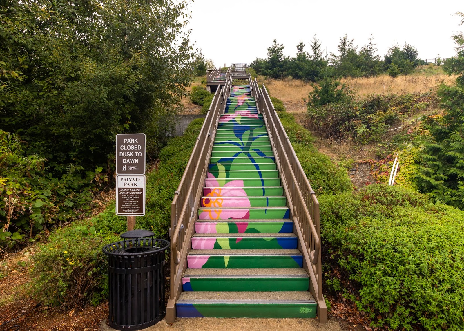 Green and pink staircase mural featuring local foliage 