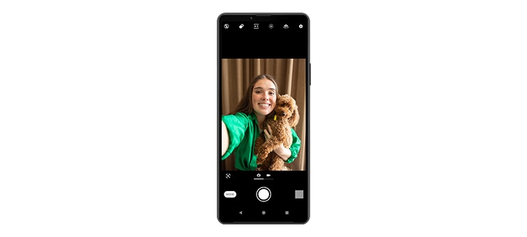 An Xperia 10 IV in portrait position, displaying a selfie of a woman holding a dog