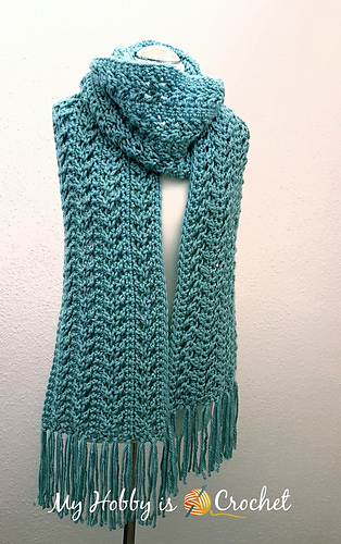long fringed teal scarf on mannequin