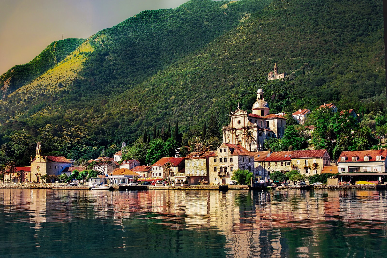 Smooth waters, red roofs and green slopes of Montenegro