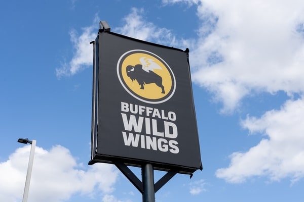 Buffalo Wild Wings signage with bright cloudy skies in the background