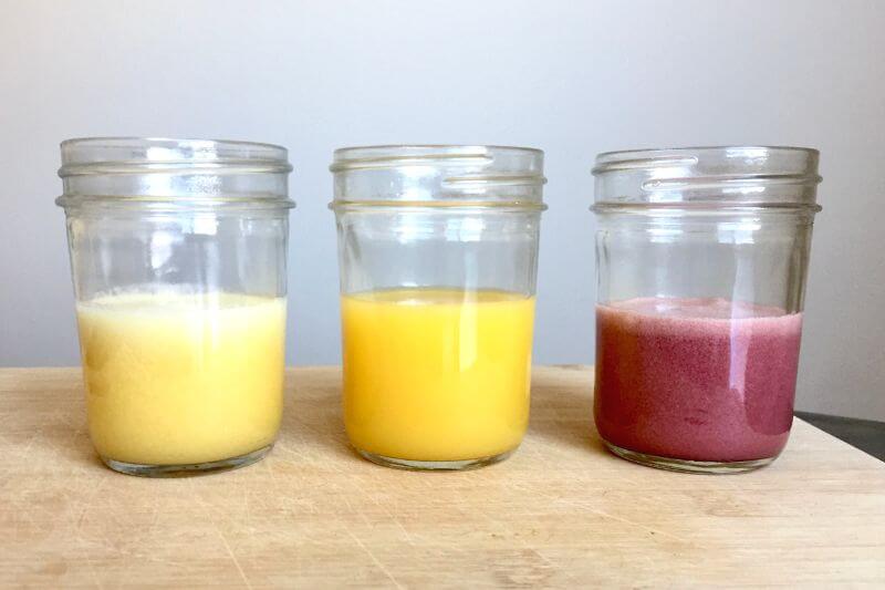 colorful variations of adrenal cocktail in three small mason jars
