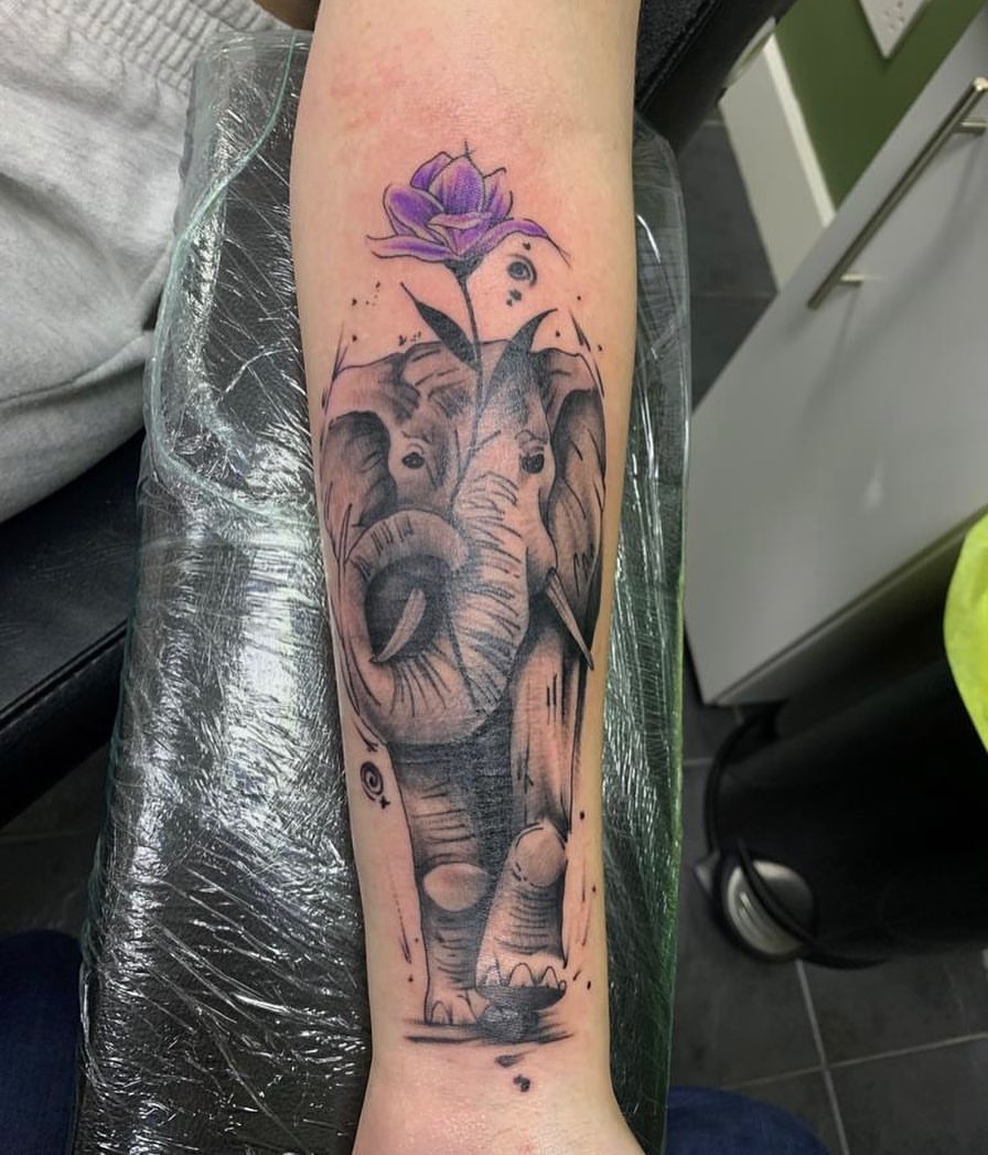 Elephant Holding Flower Tattoo