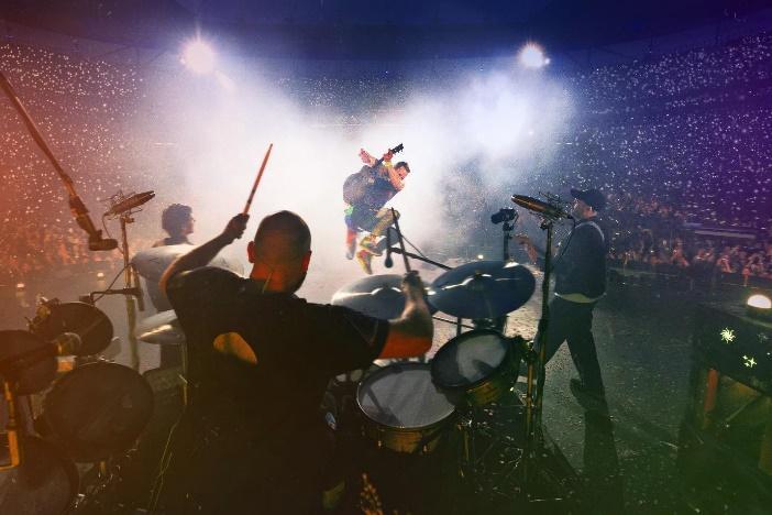 A band playing on a stage

Description automatically generated with medium confidence