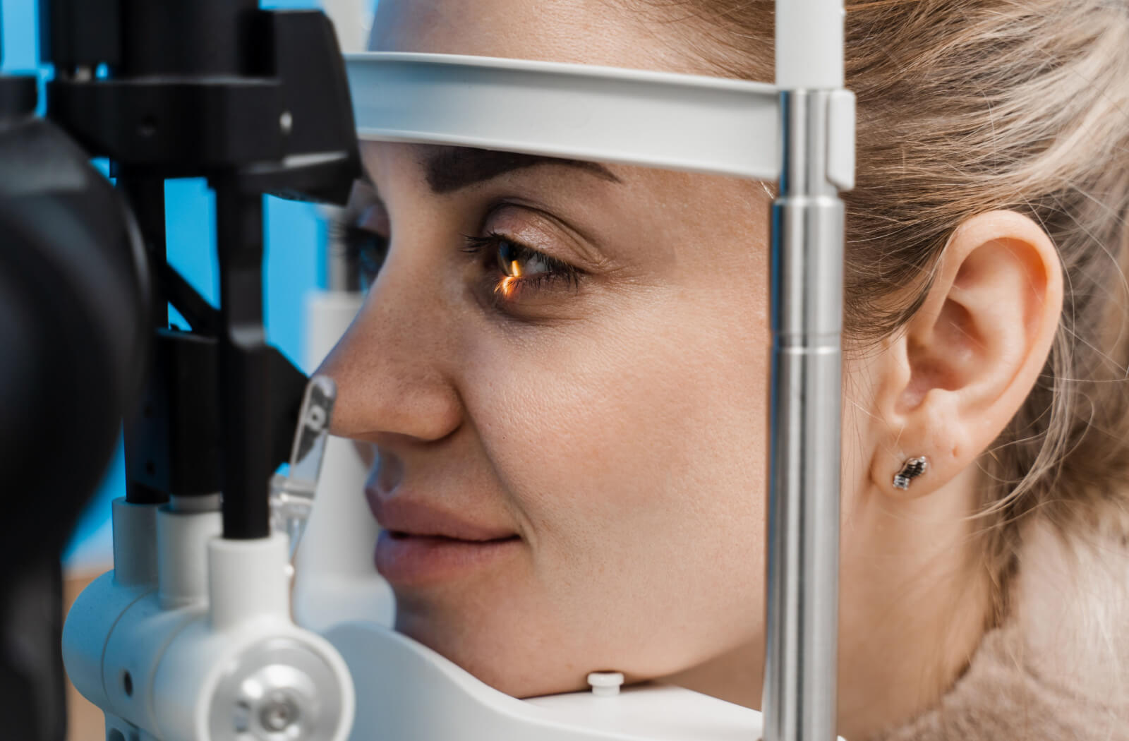 Close-up of a woman undergoing a slit-lamp exam.