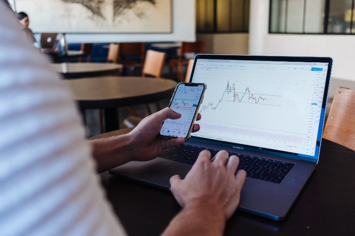 Investing graphs on a phone and laptop