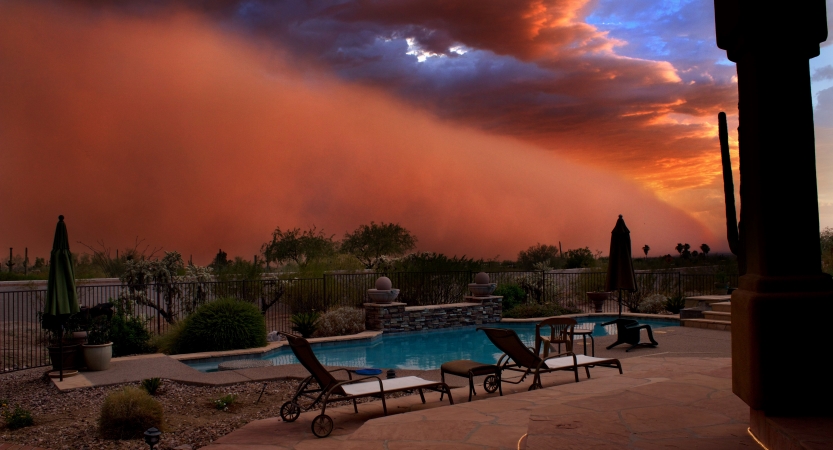 Living in Phoenix comes with images of menacing haboobs — or dust storms — approaches a backyard swimming pool in Phoenix, Arizona.
    