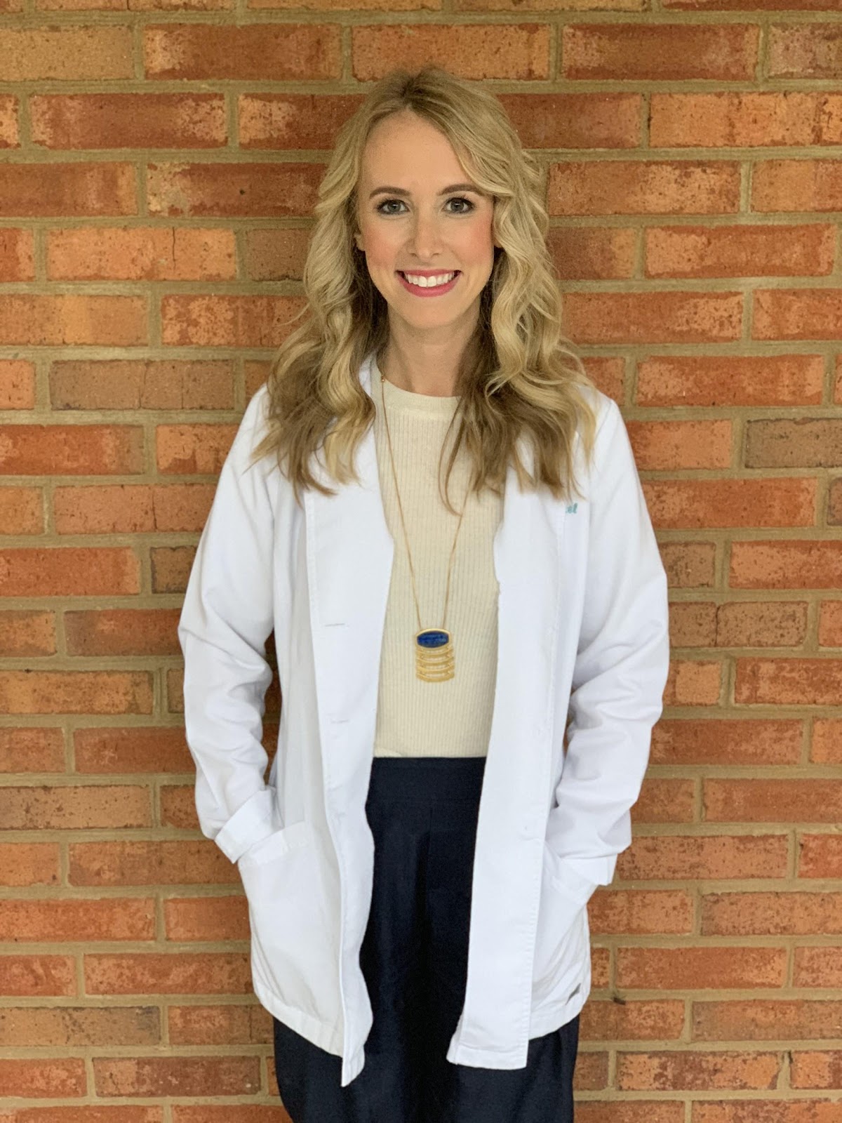 Photo of author Whitney Weingarten FNP-C smiling and wearing a white coat.