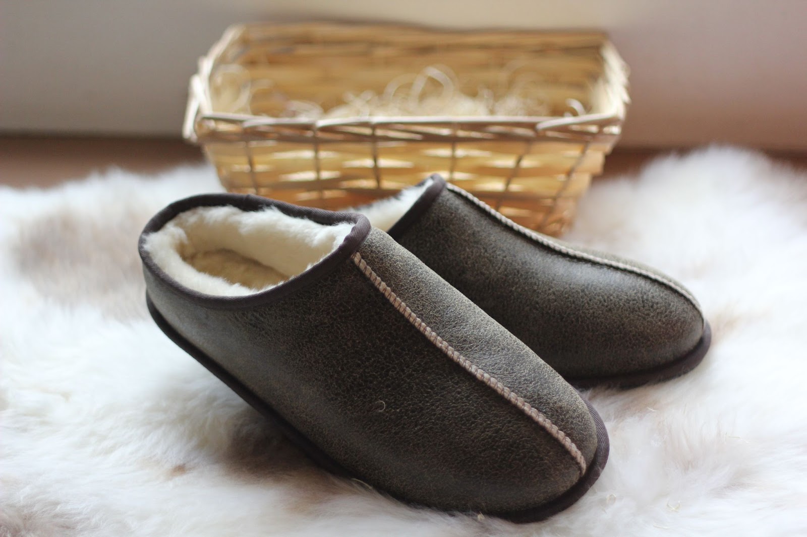 Men’s Brown Sheepskin Mule Slippers with a leather finish on a sheepskin rug