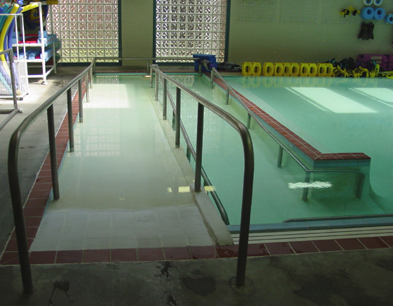 The entrance ramp to a human therapy pool located in a rehabilitation hospital in a metropolitan area