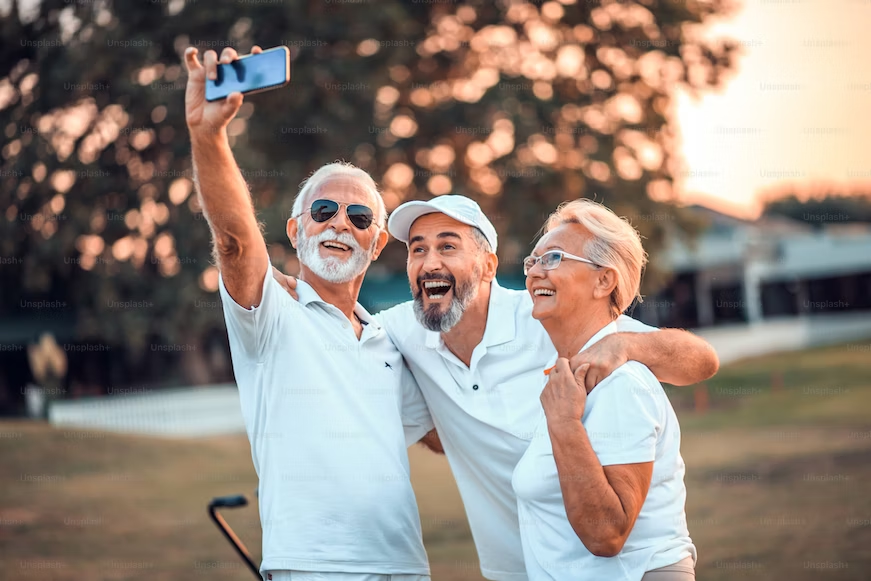 Three seniors with white shirts taking a selfie
