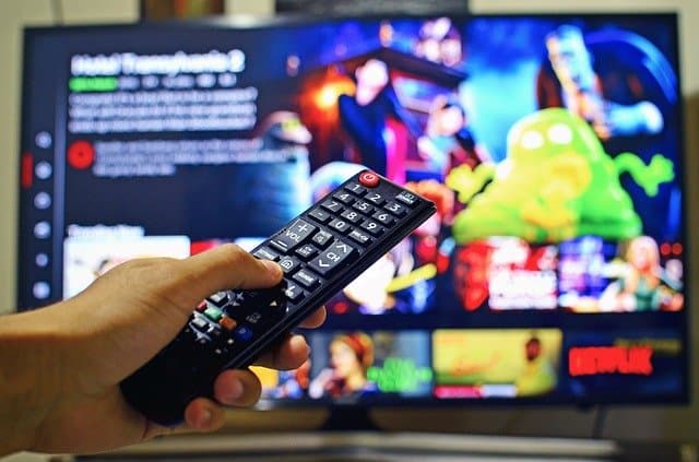 Remote control in front of TV with Netflix on. 