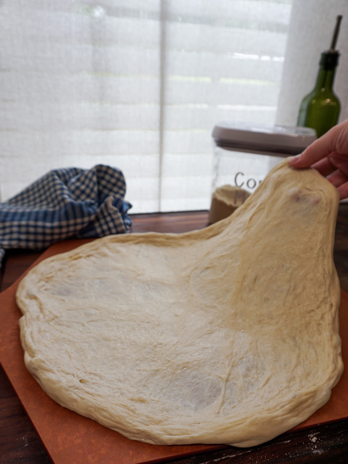 pizza dough being stretched by hand