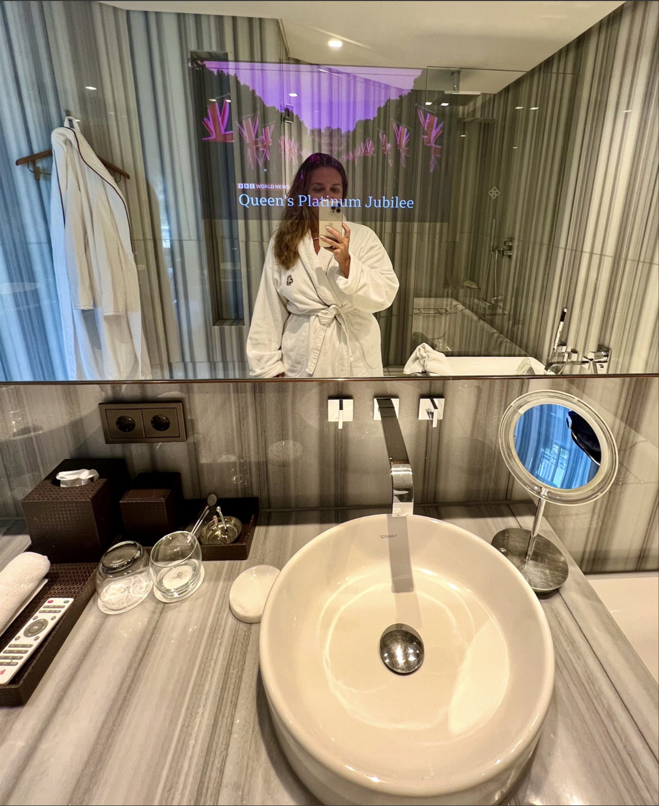 a woman taking a selfie in a bathroom