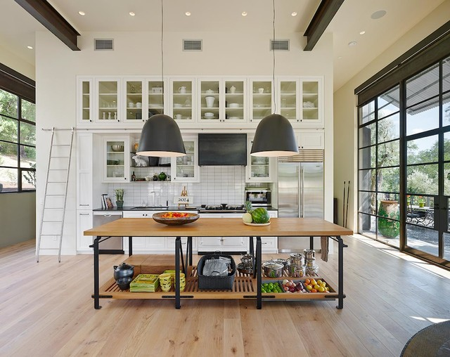 large bright california kitchen with wood island and white shaker cabinets