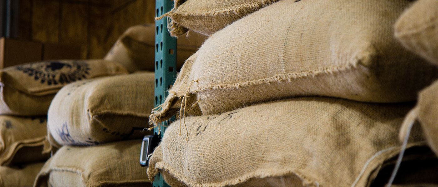 Bags of coffee beans on a shelf.