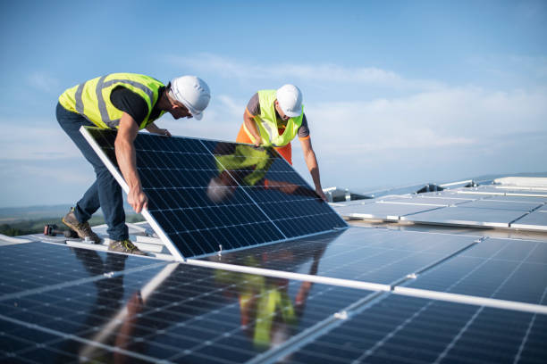 two men installing solar panel on a roof of an apartment in Lagos