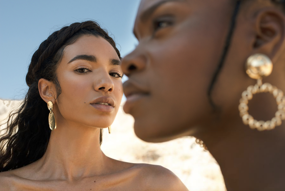 Marketing Partner photographer Demetrius Fordham's talent is undeniable. This image shows two women modeling gold earrings.