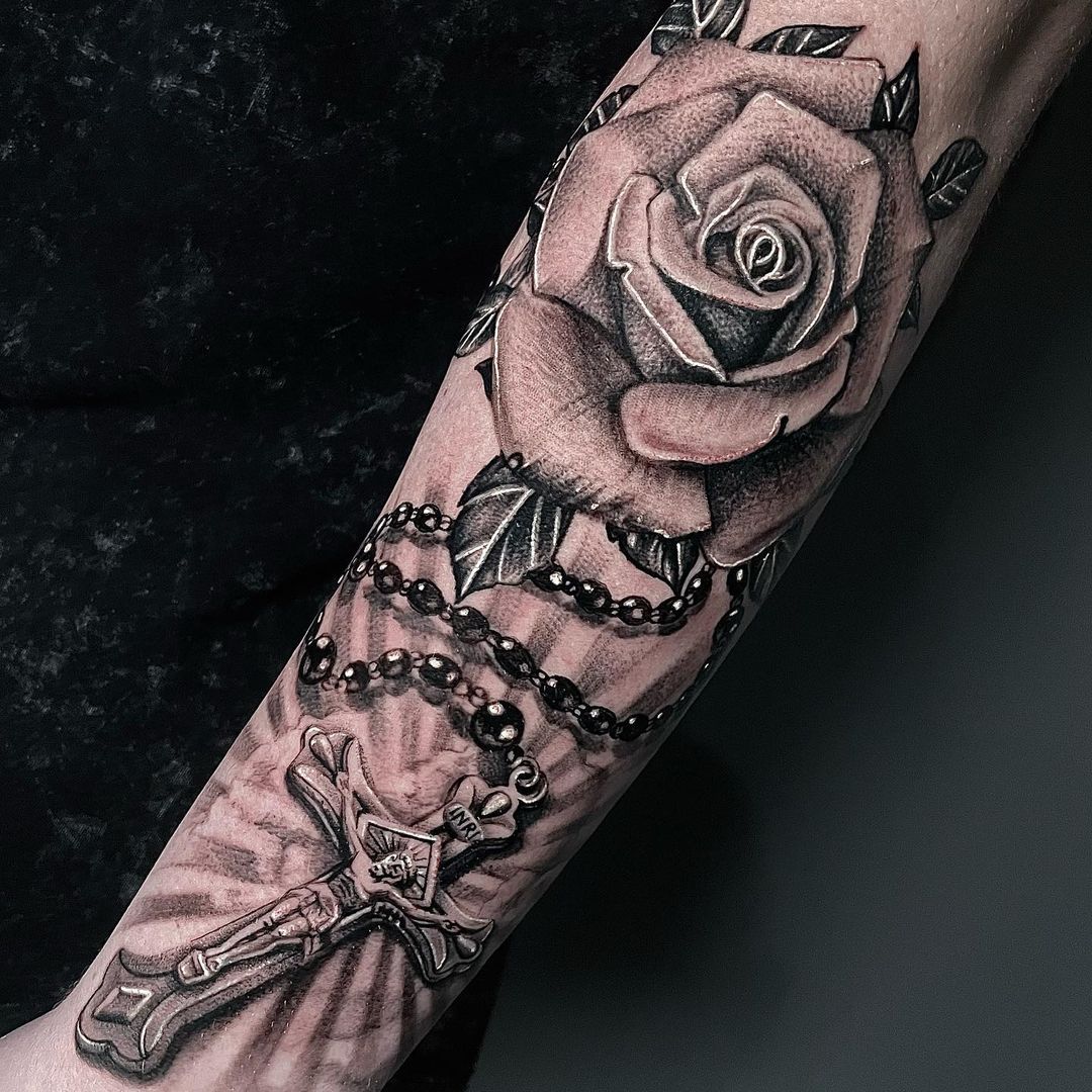 rose and forearm rosary tattoo