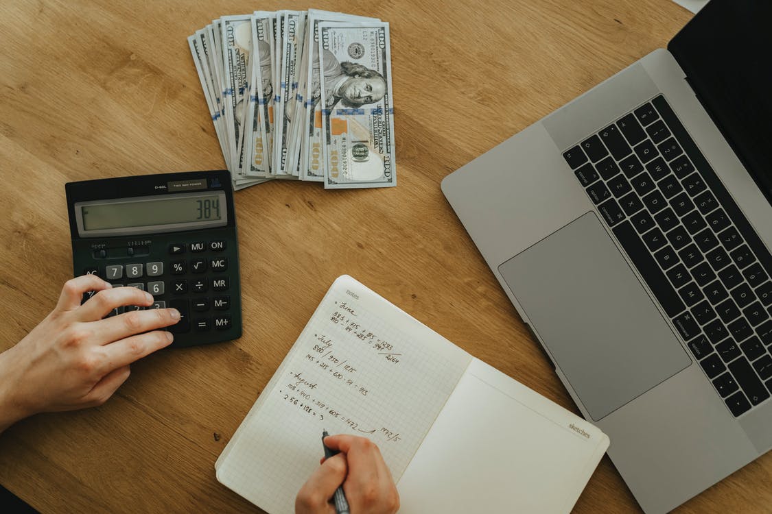 a calculator, money and laptop