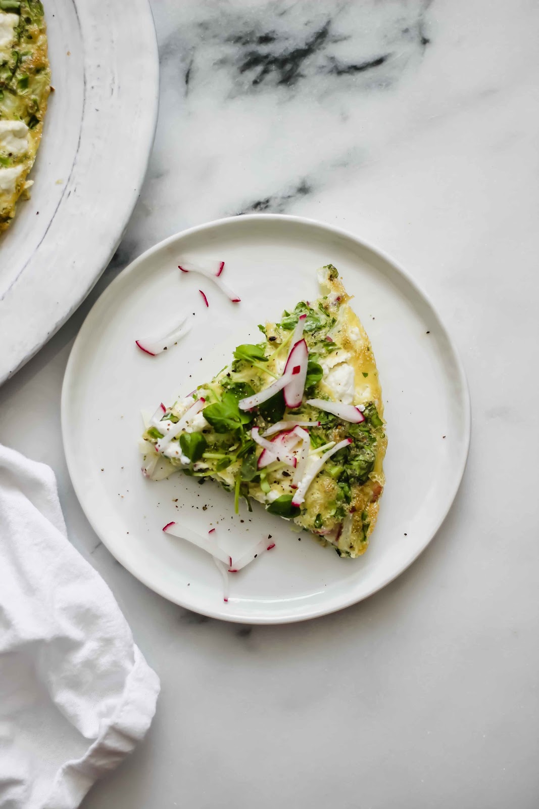 spring frittata on a marble backdrop