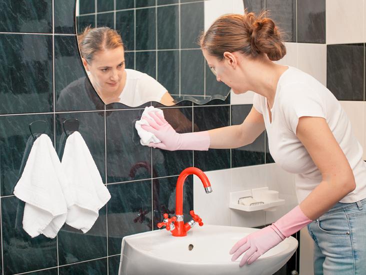 WeServe Woman cleaning bathroom tiles from black modl