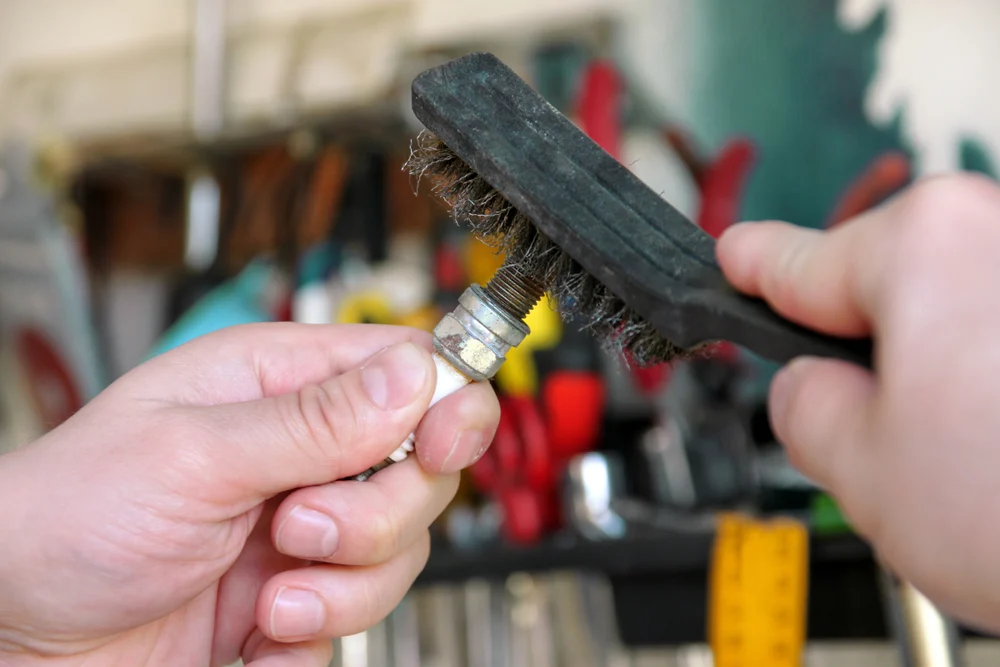 person Cleaning the Spark Plug