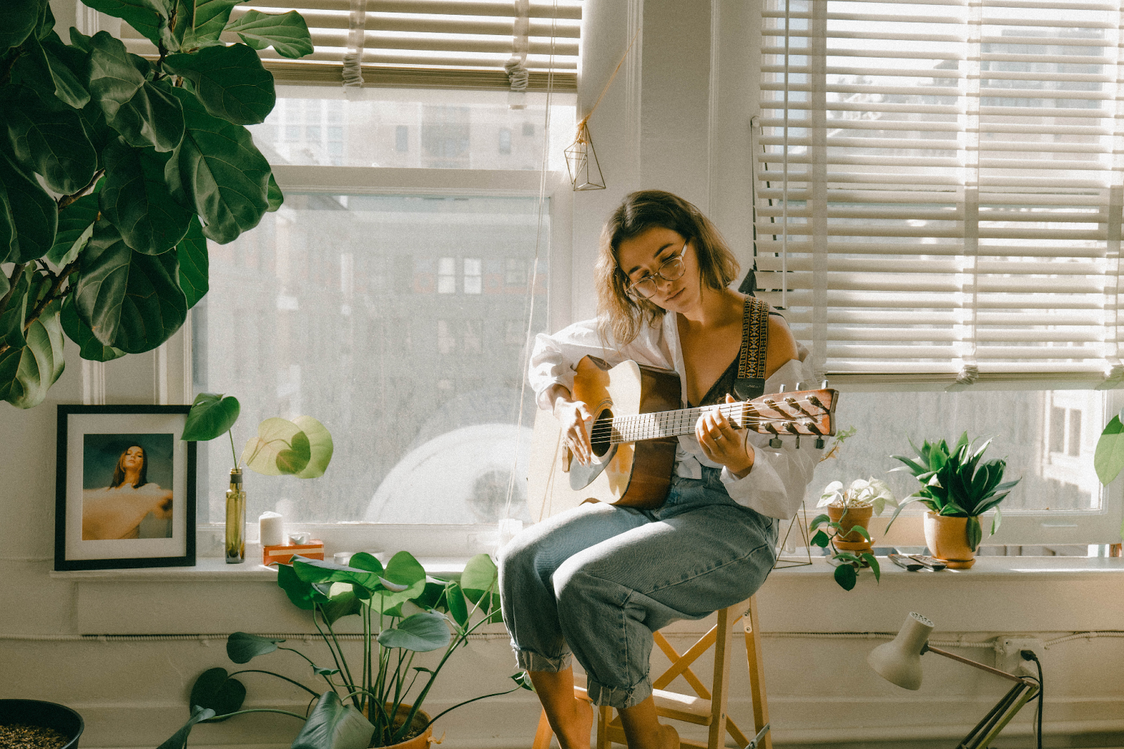girl sitting playing guitar