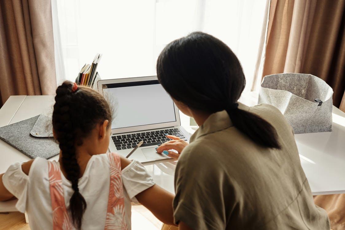 Mother Helping her Daughter with Homework - Amazing ways to stay on schedule in your homeschool