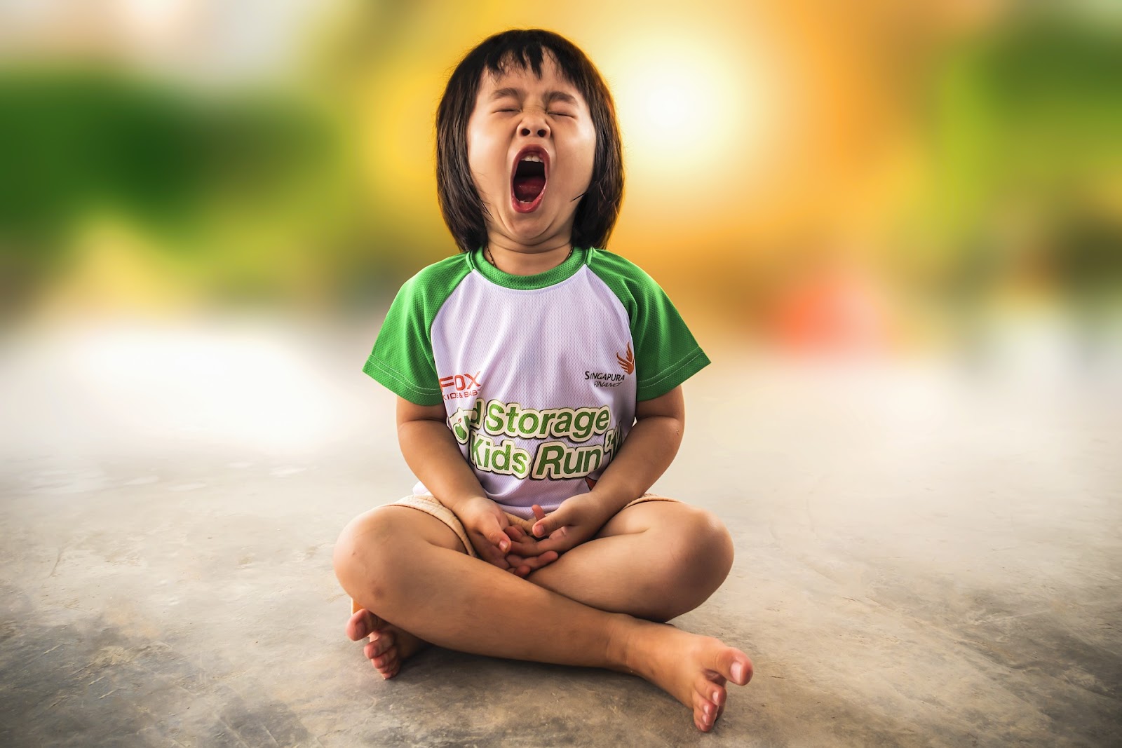 This is an image of a young girl mid-yawn.