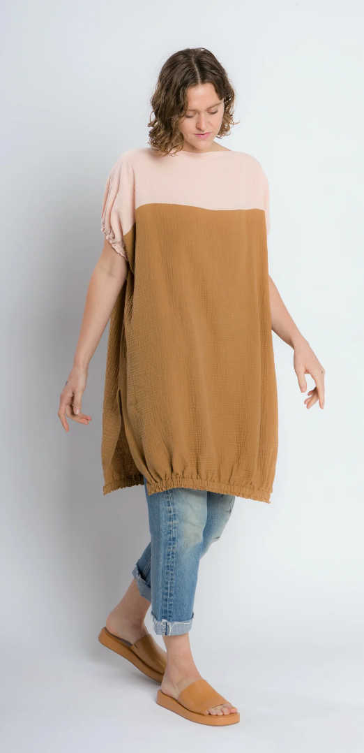 A loose tunic with elasticized short sleeves, a boat neck, and slits in the side.  Both front and back hems are also elasticised.  This version is made in two colors - the yoke is a peach, the body is a golden tan.
