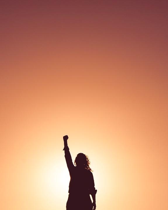 A silhouette of a person raising the hand up in the air

Description automatically generated with low confidence