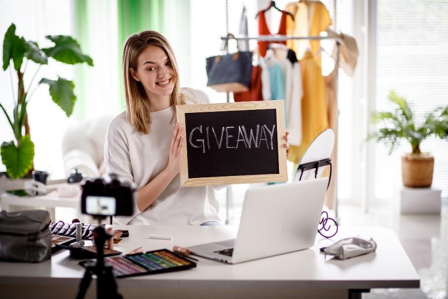 Woman holding giveaway sign