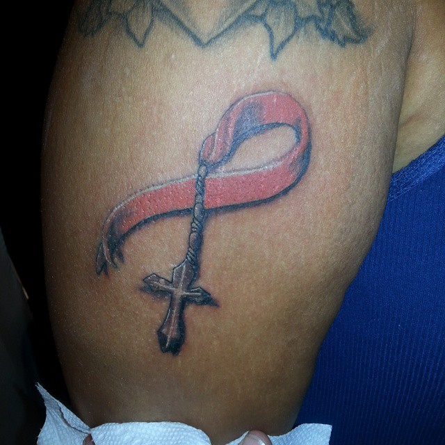 Red Ribbon Holding Cross Tattoo