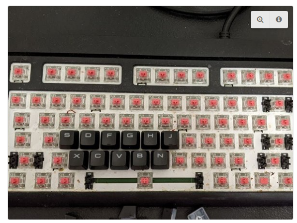 To fix gaming keyboard switch issues, first lift the keycaps and remove the back cover.
