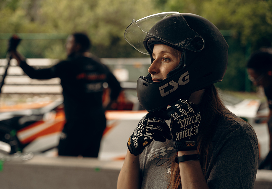 Alanis King fastens a helmet before attempting a pit crew practice after training for two days. Image photographed by Will Crooks for Road & Track magazine.