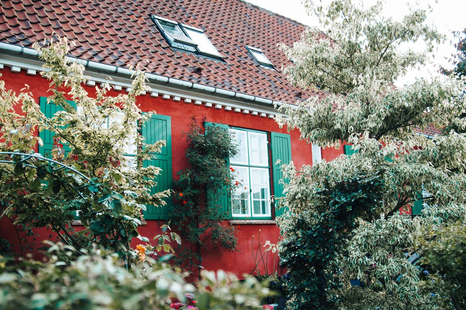 red house with green shutters 