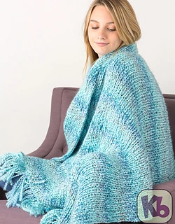 woman covered in blue loom knit blanket