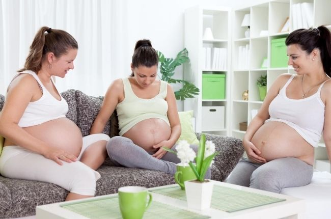 3 pregnant ladies sitting together
